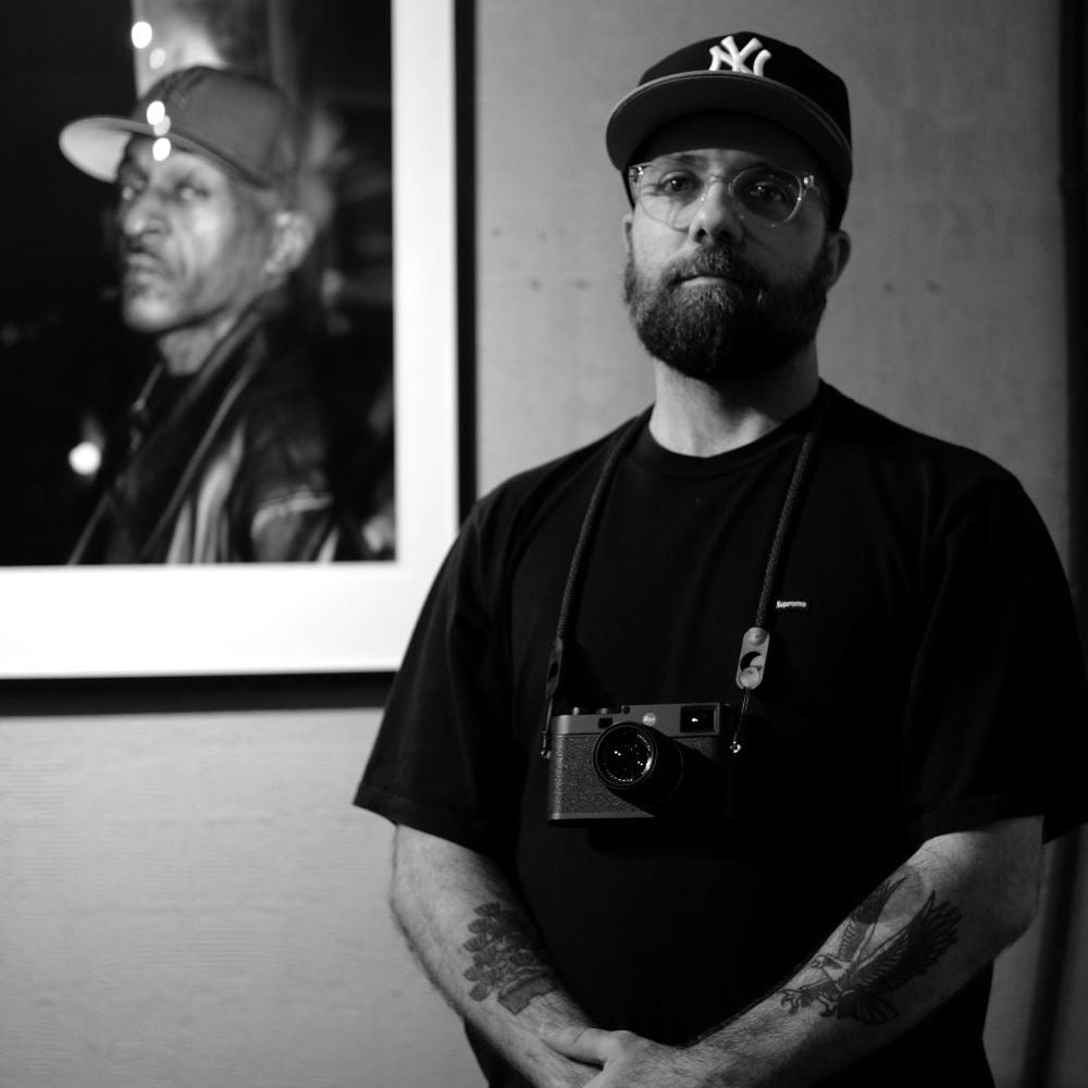 Nicola Antonazzo standing in front of his Rakim's photo in Tokyo, Japan.